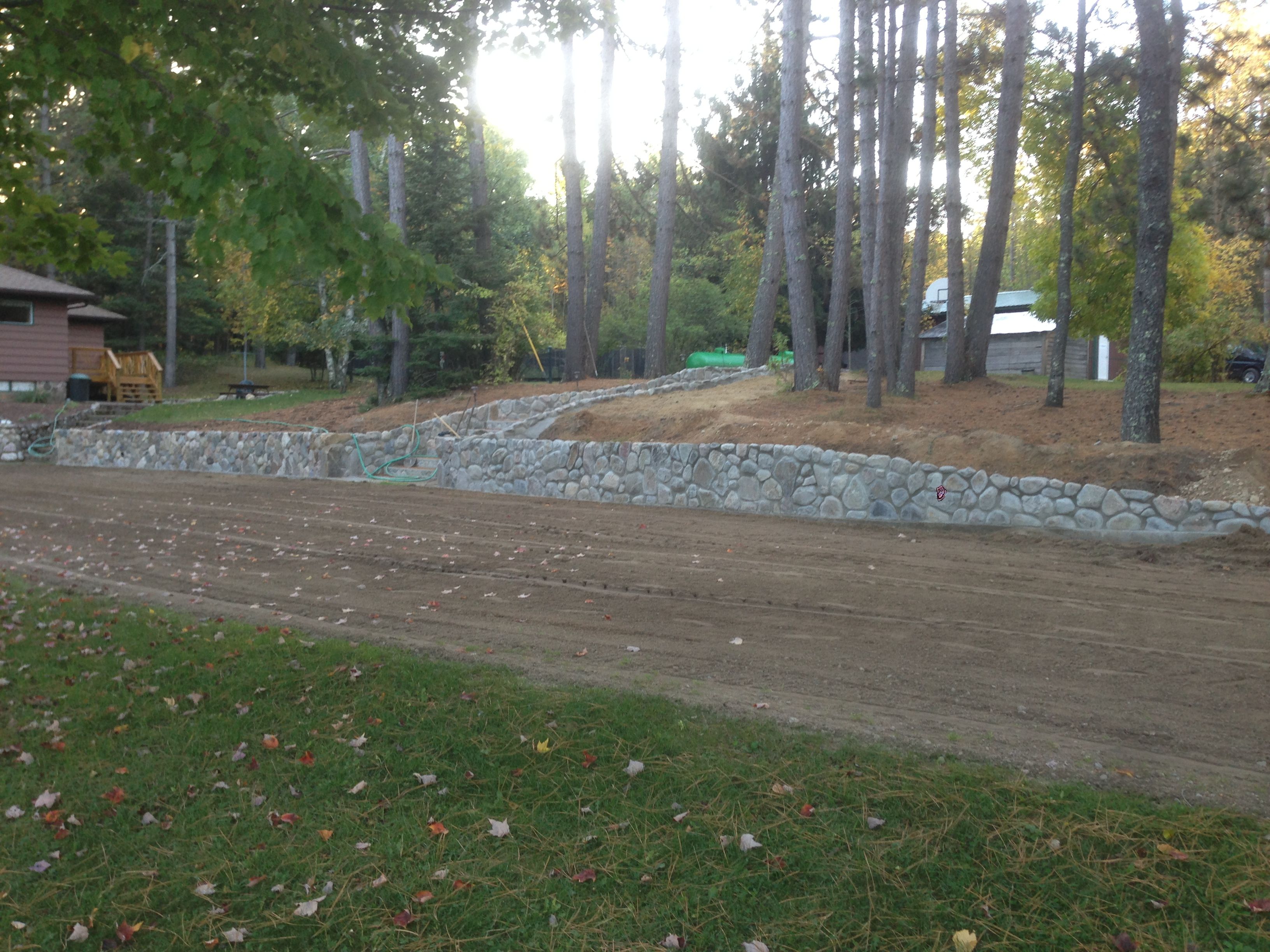 October 2013 - Ross Coyer and Gary Coyer built a continuation of Splitrocks walls and a stairway leading to the fish cleaning house and basketball court