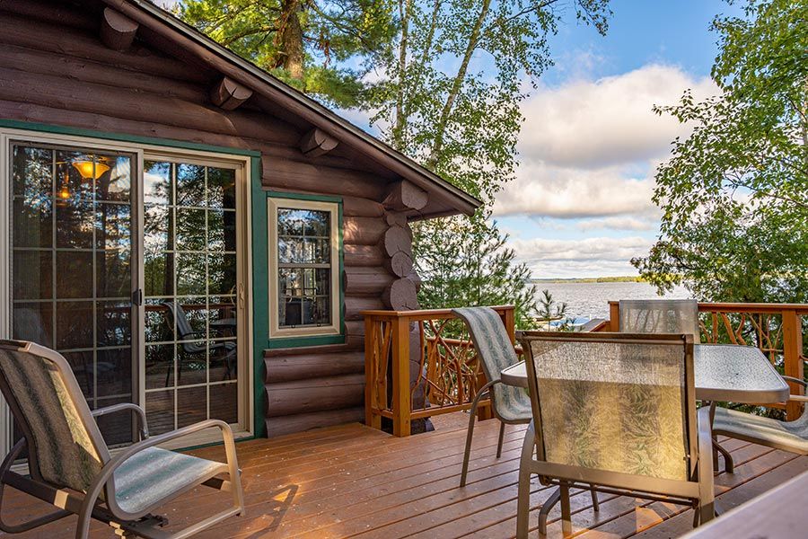 Lakefront cabin deck overlooking lake at Cabin O' Pines Resort & Campground